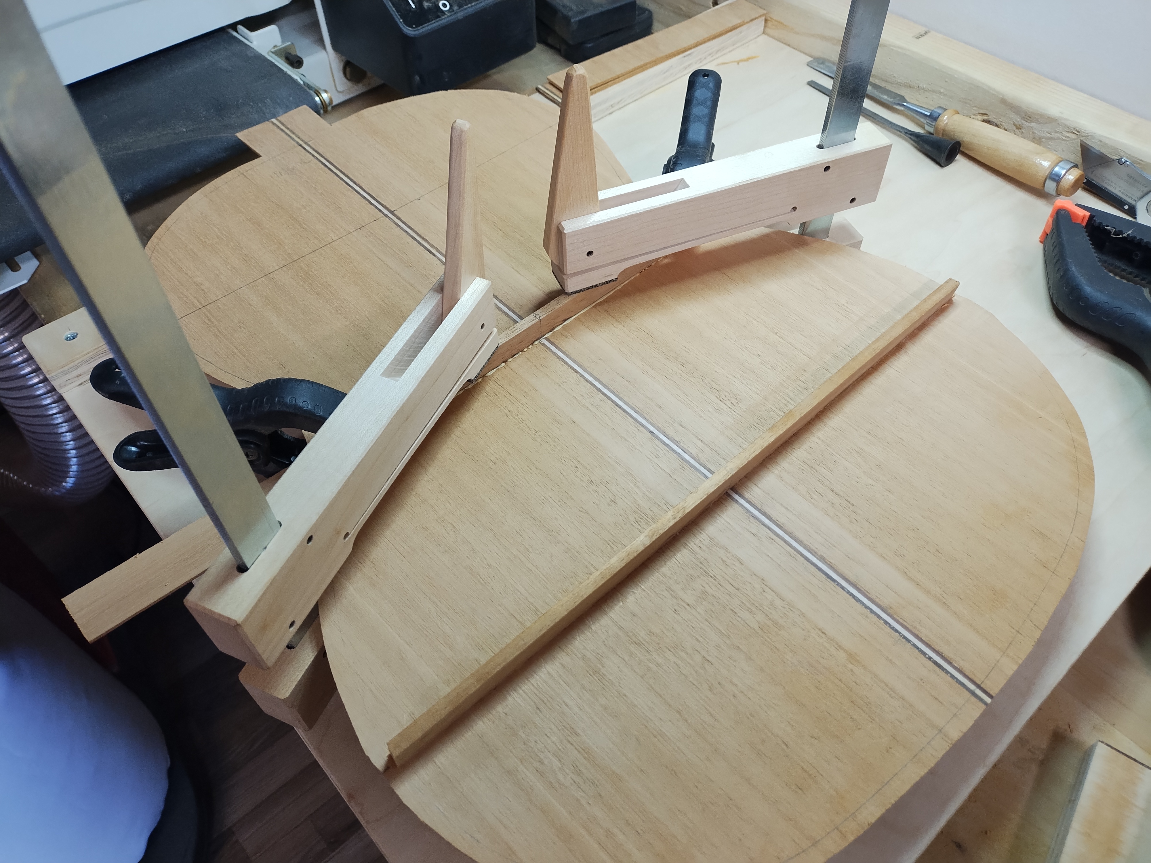 Classical guitar back being braced in the workshop