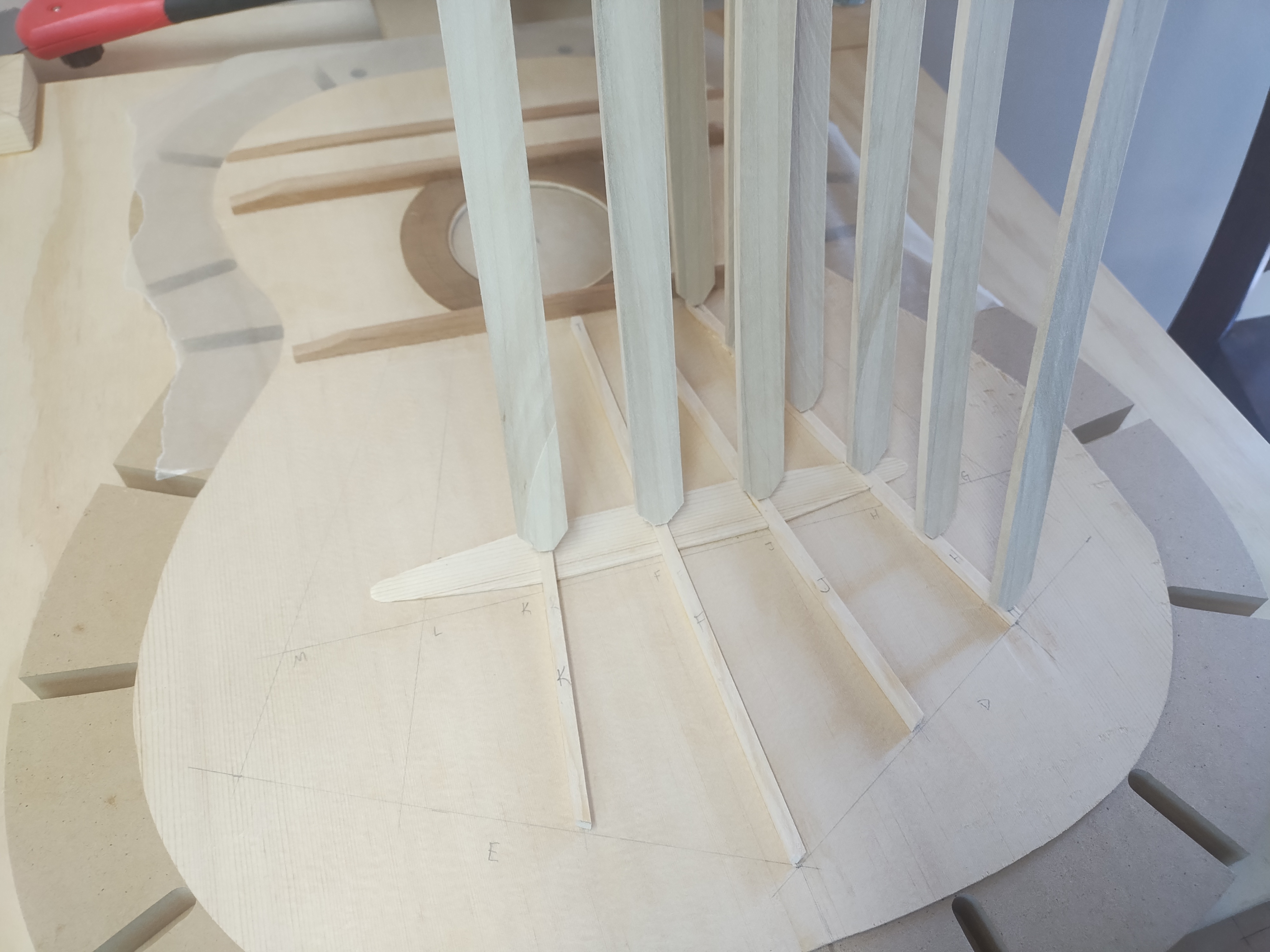 Classical guitar soundboard being braced in the workshop