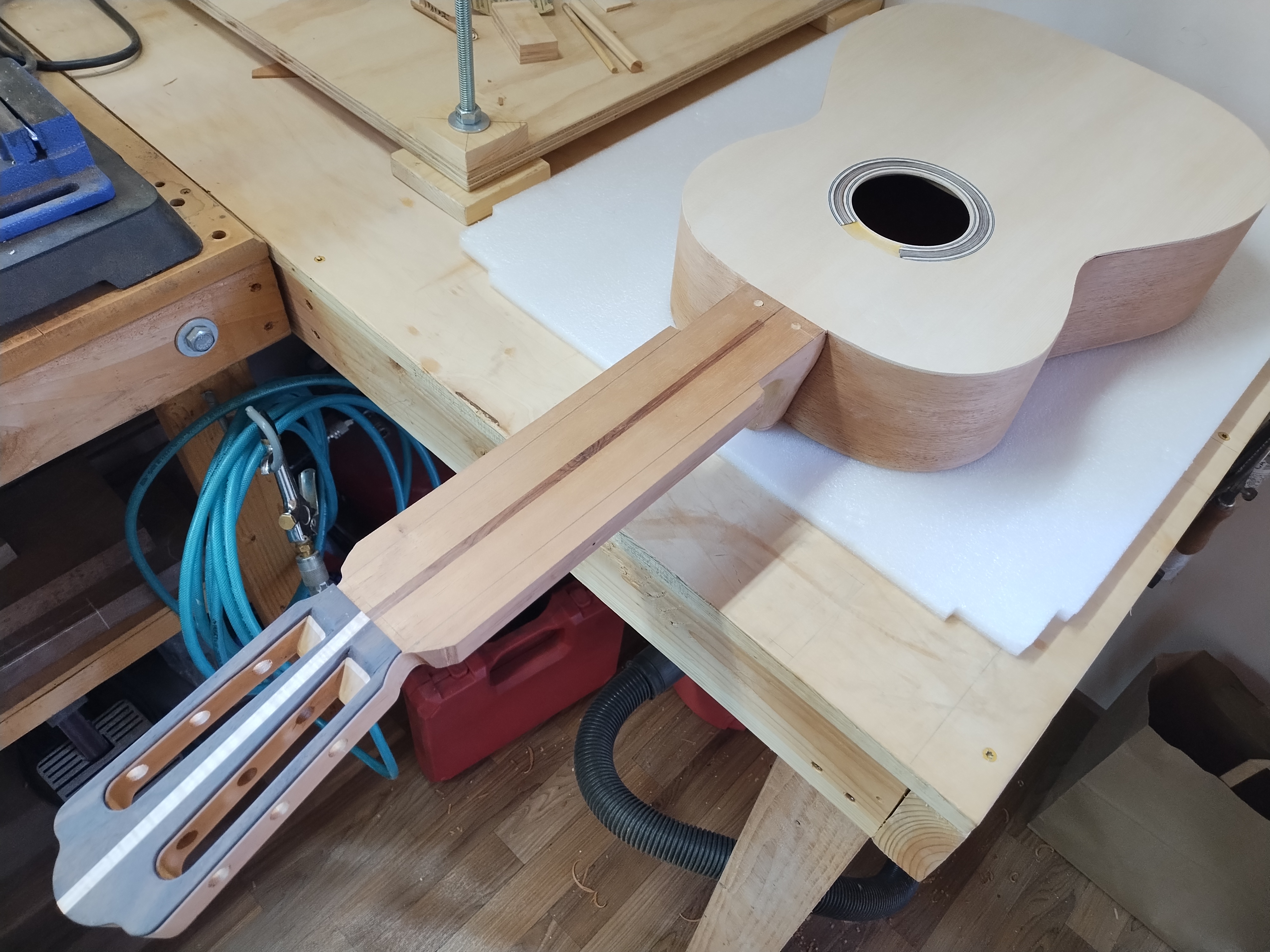 Classical guitar body and neck during workshop assembly